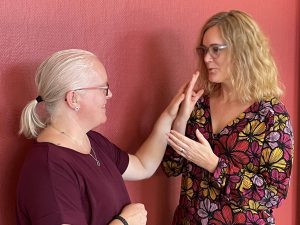 Nkcdb:s Linda Eriksson och Caroline Lindström tecknar taktilt med varandra. Foto.