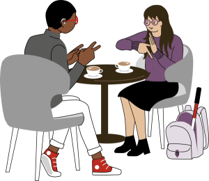 Två personer vid bord tecknar till varandra