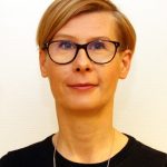 Porträttbild på Jessika Rylander. Hon har kort ljusbrunt hår i en sidbena, bär markerade glasögon, svart tröja och har ett silverhalsband runt halsen. Foto.